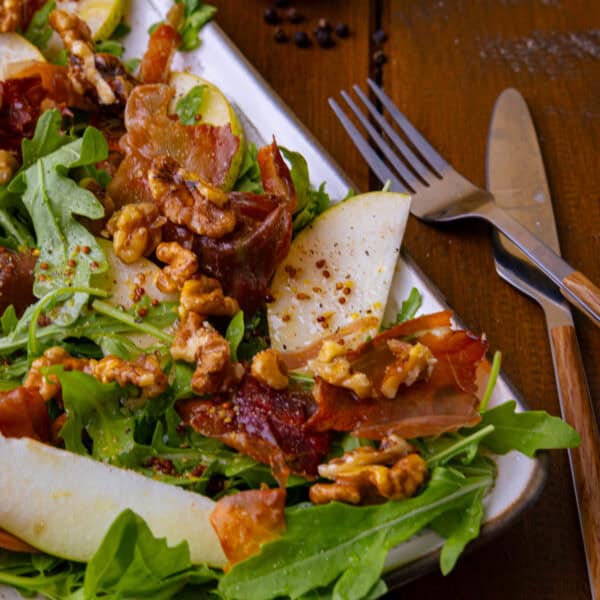 Die perfekte Sommer-Balance: Rucola-Salat mit saftiger Birne, krossem Serrano & karamellisierten Walnüssen